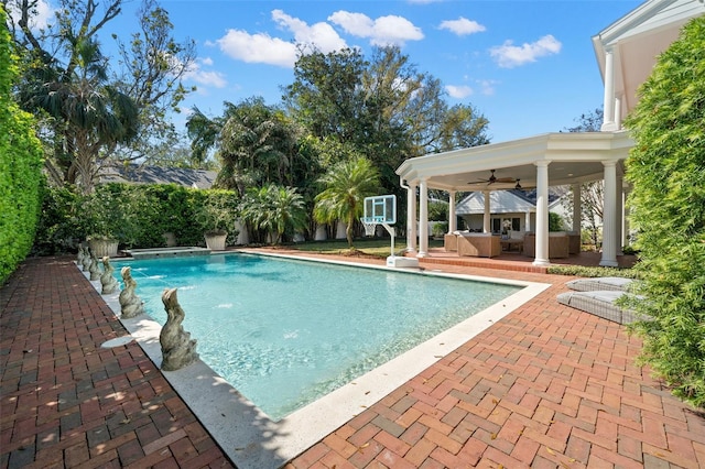 outdoor pool featuring ceiling fan, a patio area, and fence