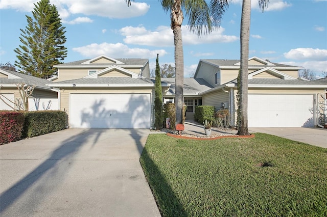 traditional home featuring a garage, concrete driveway, and a front yard