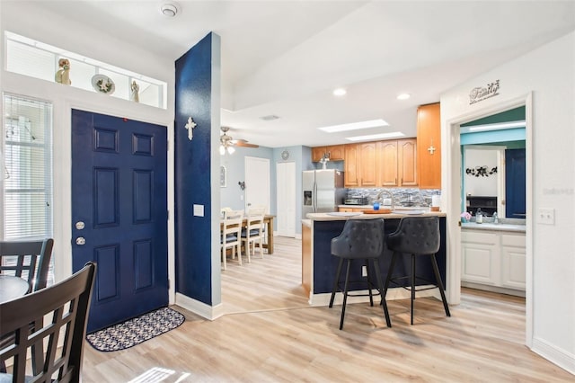 foyer with ceiling fan, recessed lighting, baseboards, and light wood-style floors