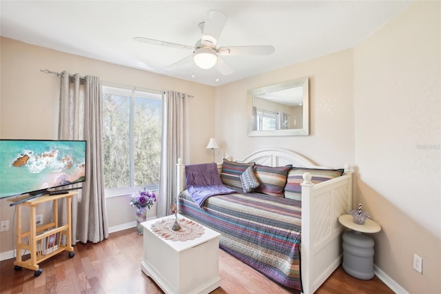 bedroom with ceiling fan, baseboards, and wood finished floors