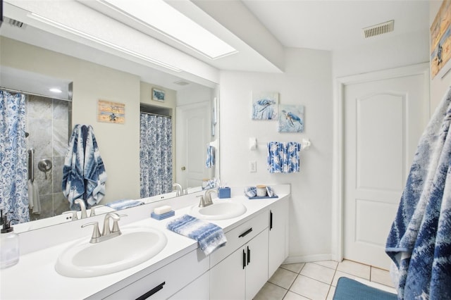 full bathroom with tile patterned flooring, visible vents, a sink, and double vanity