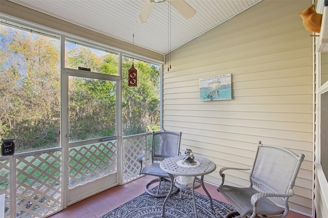 sunroom featuring lofted ceiling and ceiling fan