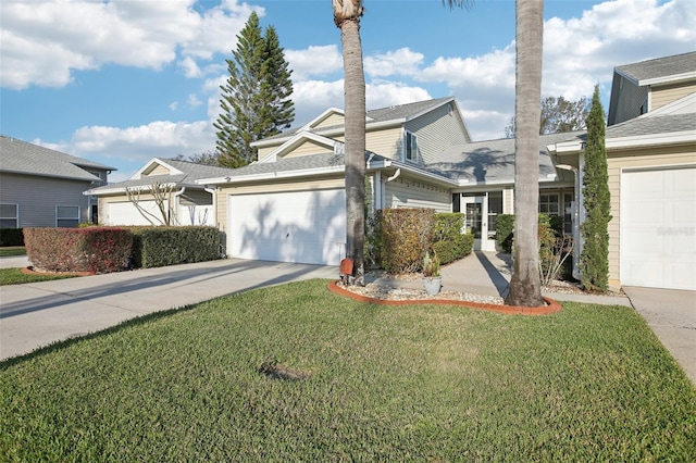 traditional-style house with driveway, an attached garage, and a front yard