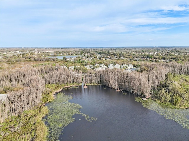 birds eye view of property featuring a water view and a wooded view