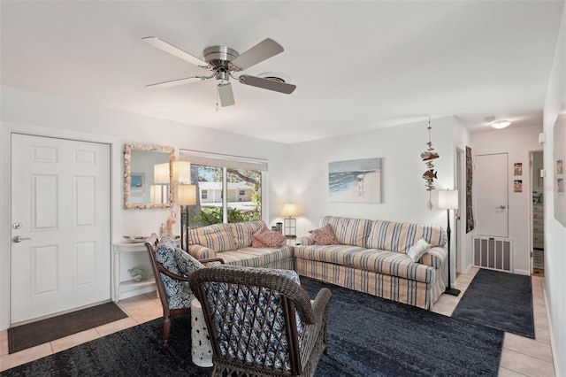 living room featuring a ceiling fan, visible vents, and light tile patterned floors