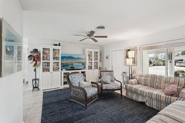 living area with visible vents, ceiling fan, and light tile patterned floors