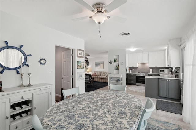 dining area with visible vents, ceiling fan, and light tile patterned floors