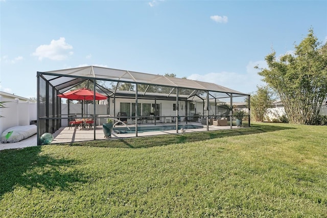 rear view of house featuring an outdoor pool, glass enclosure, a patio, and a lawn