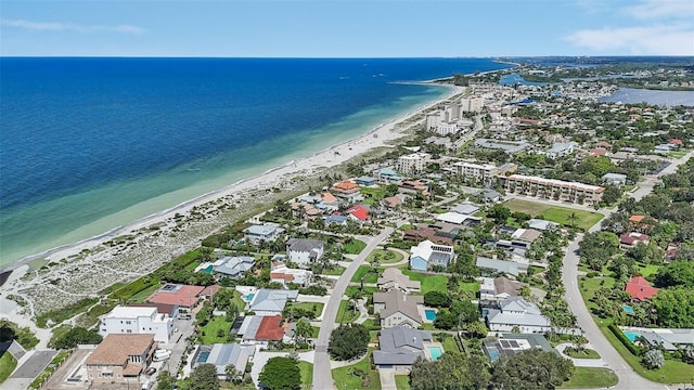 birds eye view of property with a water view and a view of the beach