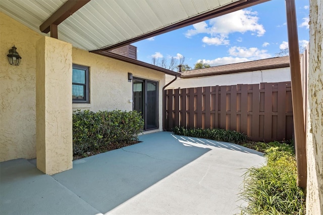 view of patio featuring fence