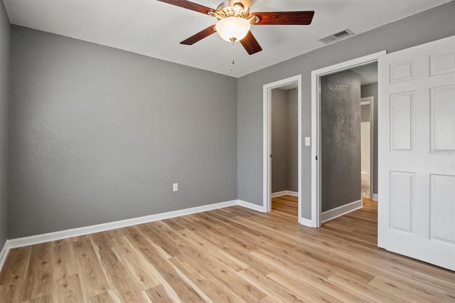 unfurnished bedroom featuring visible vents, ceiling fan, light wood-style flooring, and baseboards