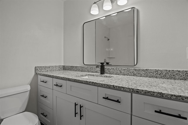 bathroom with toilet and vanity