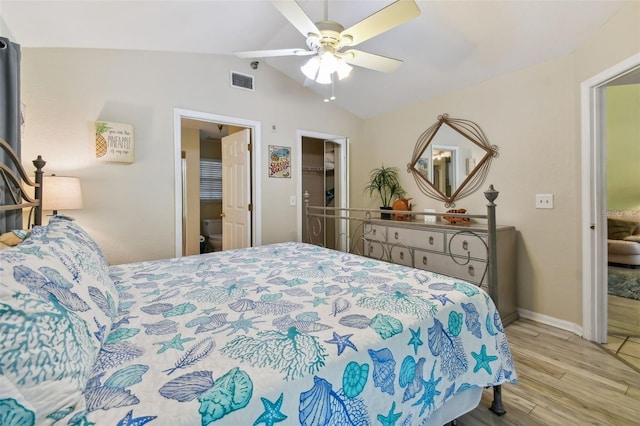 bedroom with wood finished floors, visible vents, a ceiling fan, vaulted ceiling, and a spacious closet