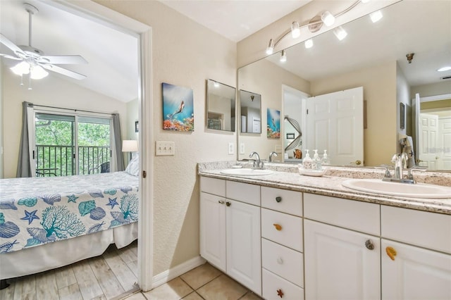 ensuite bathroom with double vanity, ensuite bath, a sink, and a ceiling fan