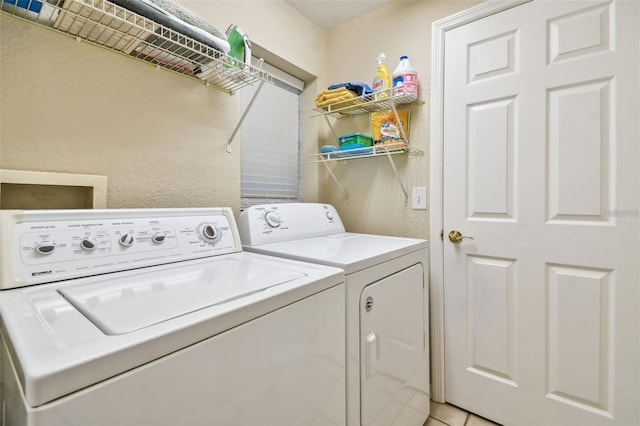 laundry room featuring a textured wall, laundry area, and independent washer and dryer