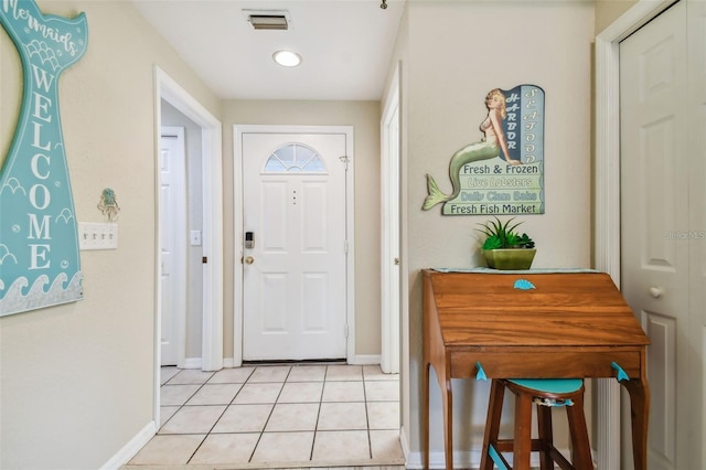 foyer featuring light tile patterned flooring, visible vents, and baseboards