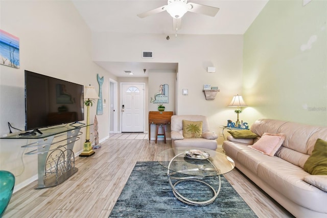 living room with ceiling fan, light wood finished floors, visible vents, and baseboards