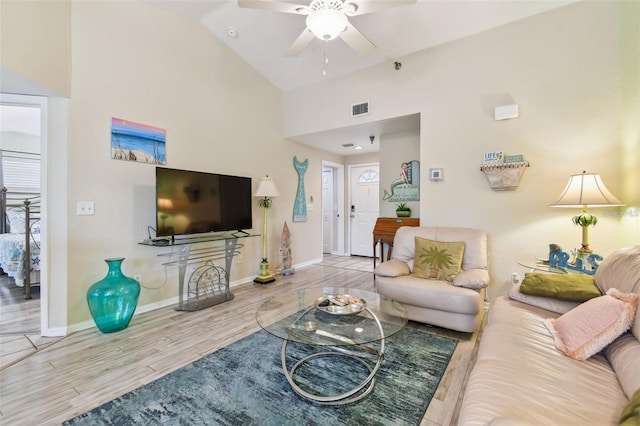 living room featuring baseboards, visible vents, a ceiling fan, wood finished floors, and high vaulted ceiling