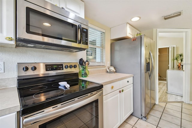 kitchen with visible vents, light countertops, appliances with stainless steel finishes, and white cabinetry