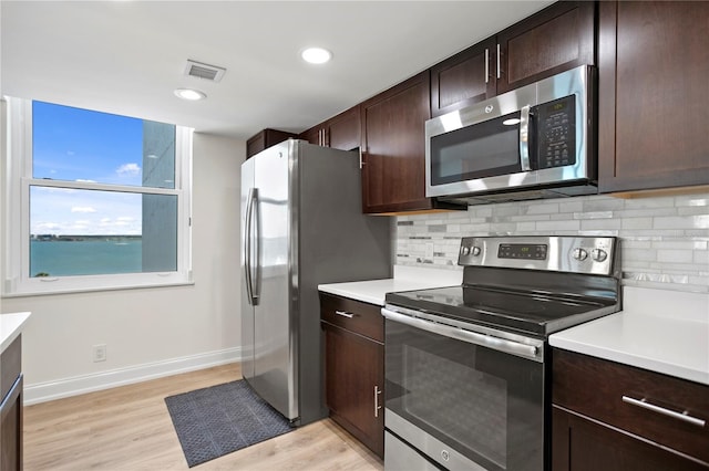 kitchen with light countertops, appliances with stainless steel finishes, and dark brown cabinetry