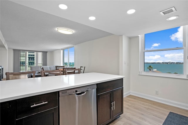 kitchen featuring plenty of natural light, visible vents, light countertops, and dishwasher