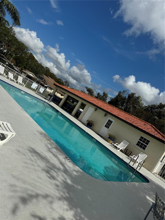 pool featuring a patio area and fence