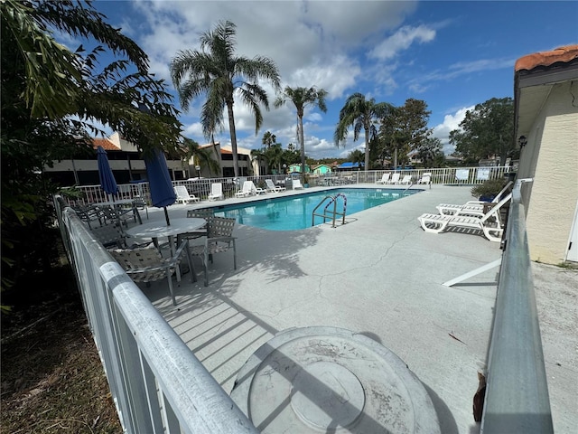 pool featuring a patio and fence