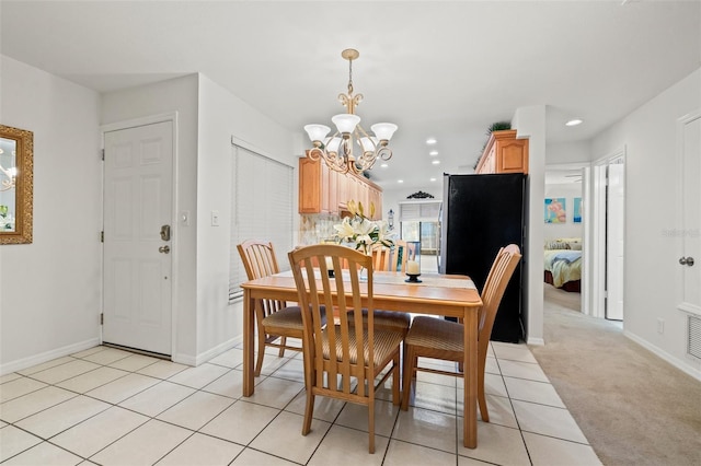 dining space featuring recessed lighting, a notable chandelier, baseboards, and light tile patterned floors