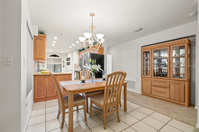 dining space with light tile patterned floors, recessed lighting, visible vents, an inviting chandelier, and light carpet