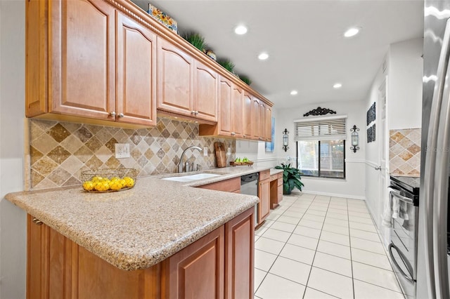 kitchen featuring light tile patterned floors, light stone counters, stainless steel appliances, a sink, and tasteful backsplash