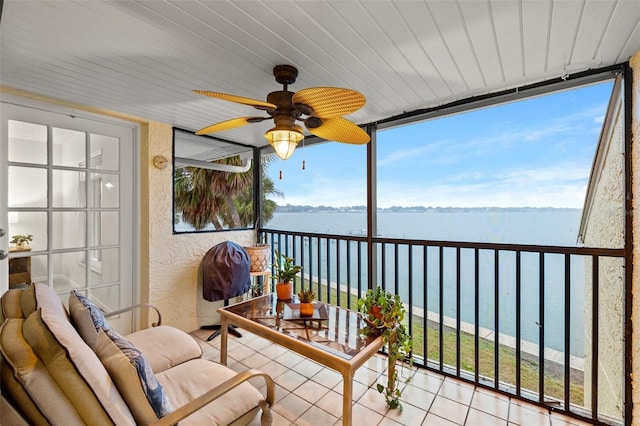 sunroom featuring a water view, ceiling fan, and wood ceiling