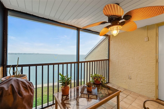 sunroom / solarium featuring a water view