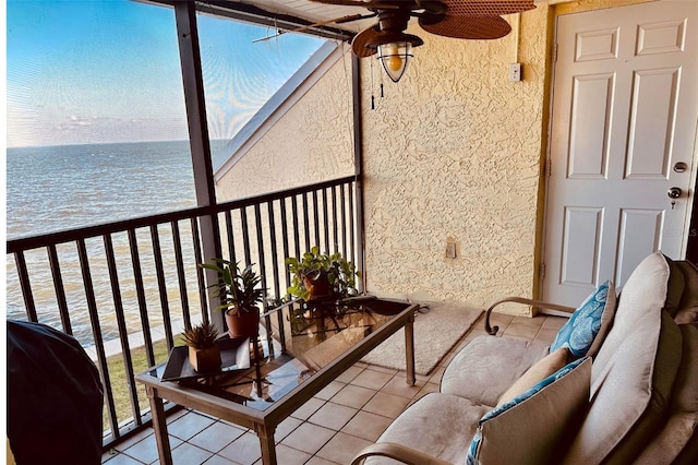 balcony with a grill, a water view, and ceiling fan