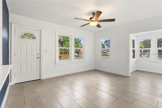 foyer featuring a ceiling fan and baseboards