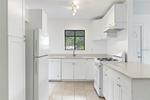 kitchen with white appliances, light tile patterned floors, light countertops, white cabinetry, and a sink