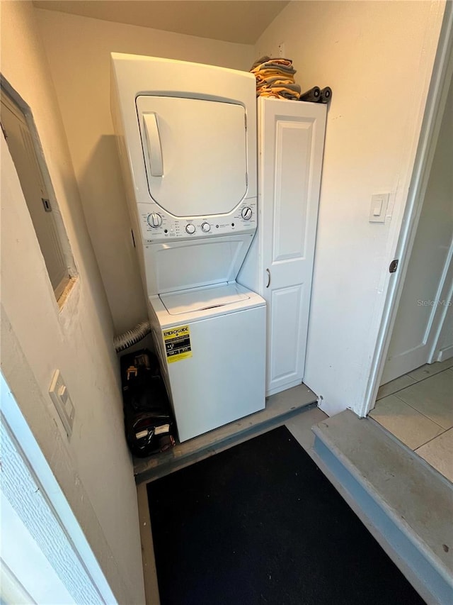 laundry room featuring laundry area and stacked washer and clothes dryer