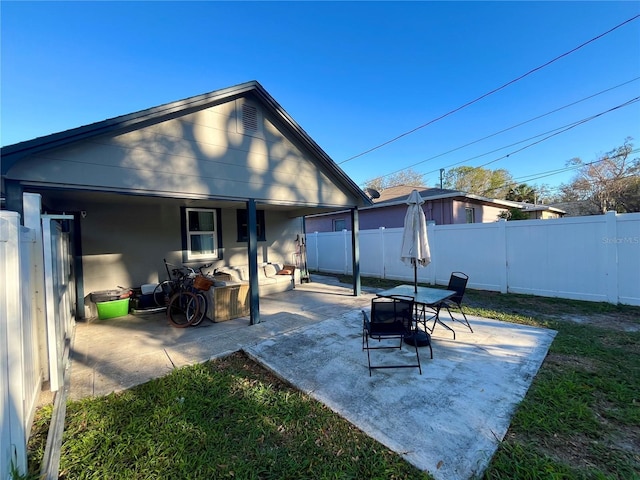 rear view of house featuring a patio area and a fenced backyard