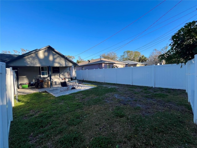 view of yard featuring a patio and a fenced backyard