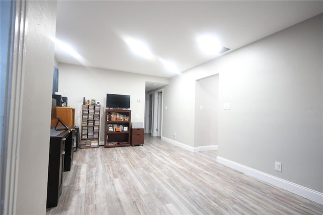 below grade area with light wood-type flooring and baseboards