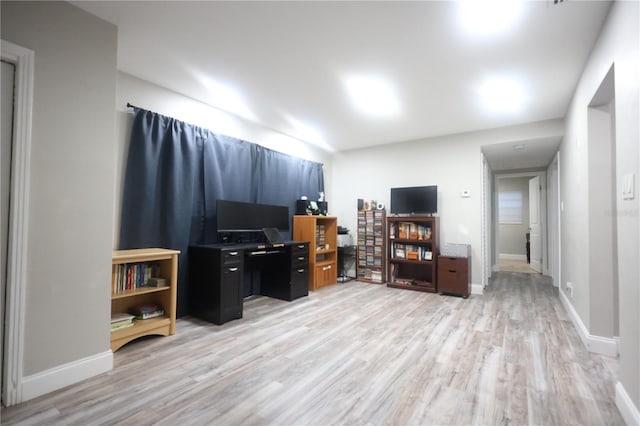 home office with baseboards and light wood-style floors