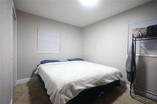 carpeted bedroom with baseboards