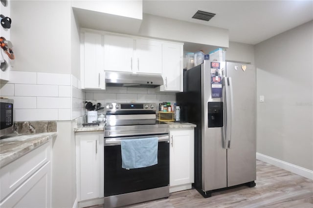 kitchen with white cabinets, under cabinet range hood, visible vents, and stainless steel appliances