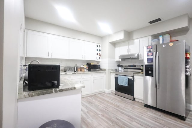 kitchen with light stone counters, visible vents, appliances with stainless steel finishes, white cabinetry, and under cabinet range hood