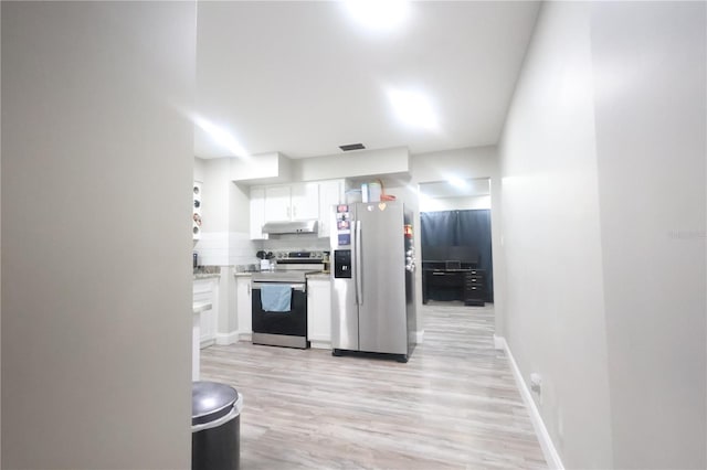 kitchen featuring under cabinet range hood, white cabinets, light countertops, appliances with stainless steel finishes, and tasteful backsplash