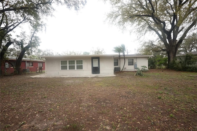 view of front of property featuring fence and a patio