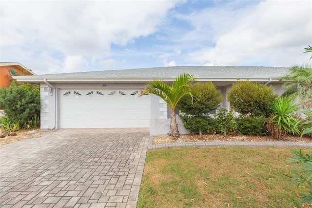 view of front facade featuring an attached garage and decorative driveway