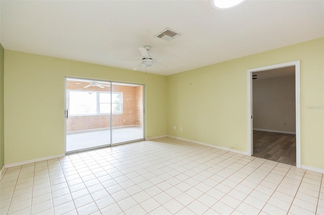 unfurnished room featuring ceiling fan, visible vents, baseboards, and light tile patterned flooring