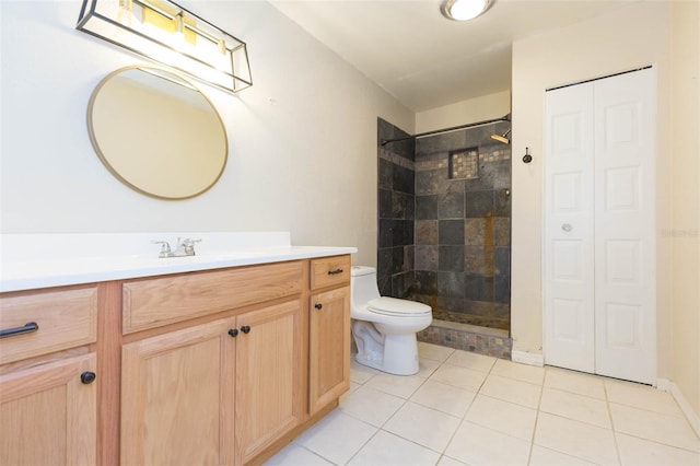 full bathroom with a walk in shower, tile patterned flooring, toilet, vanity, and a closet