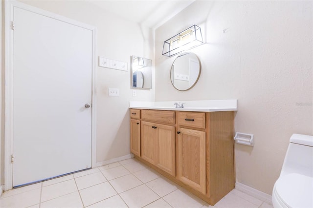 bathroom with tile patterned flooring, vanity, toilet, and baseboards