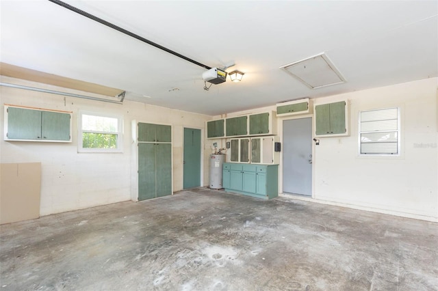 garage with water heater, concrete block wall, and a garage door opener